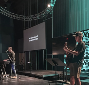 Senior Eli Hommel plays his guitar at Mt. Pleasant Christian Church.